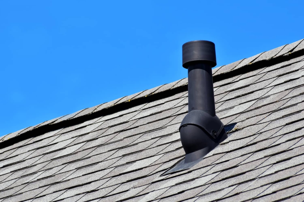 A roof vent pipe with a cover on it. 